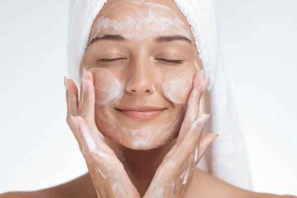 خانمی در حال پاکسازی پوست صورت خود